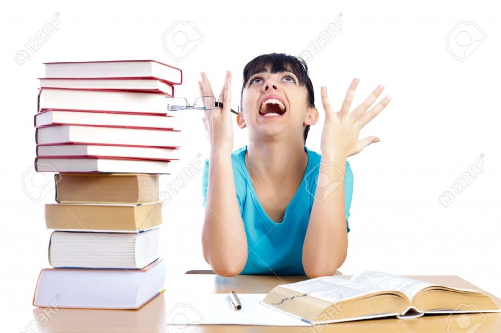 19176190-angry-student-screaming-stressfully-and-holding-glasses-while-studying-isolated-on-white-part-of-a-s-stock-photo